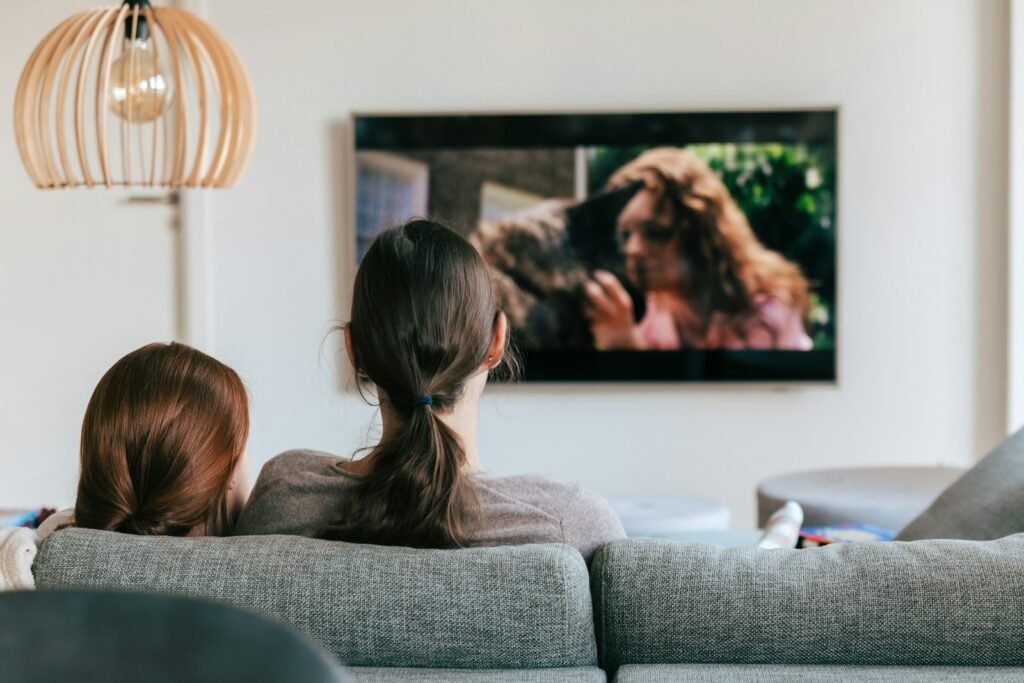 Two friends watching anime together on a couch