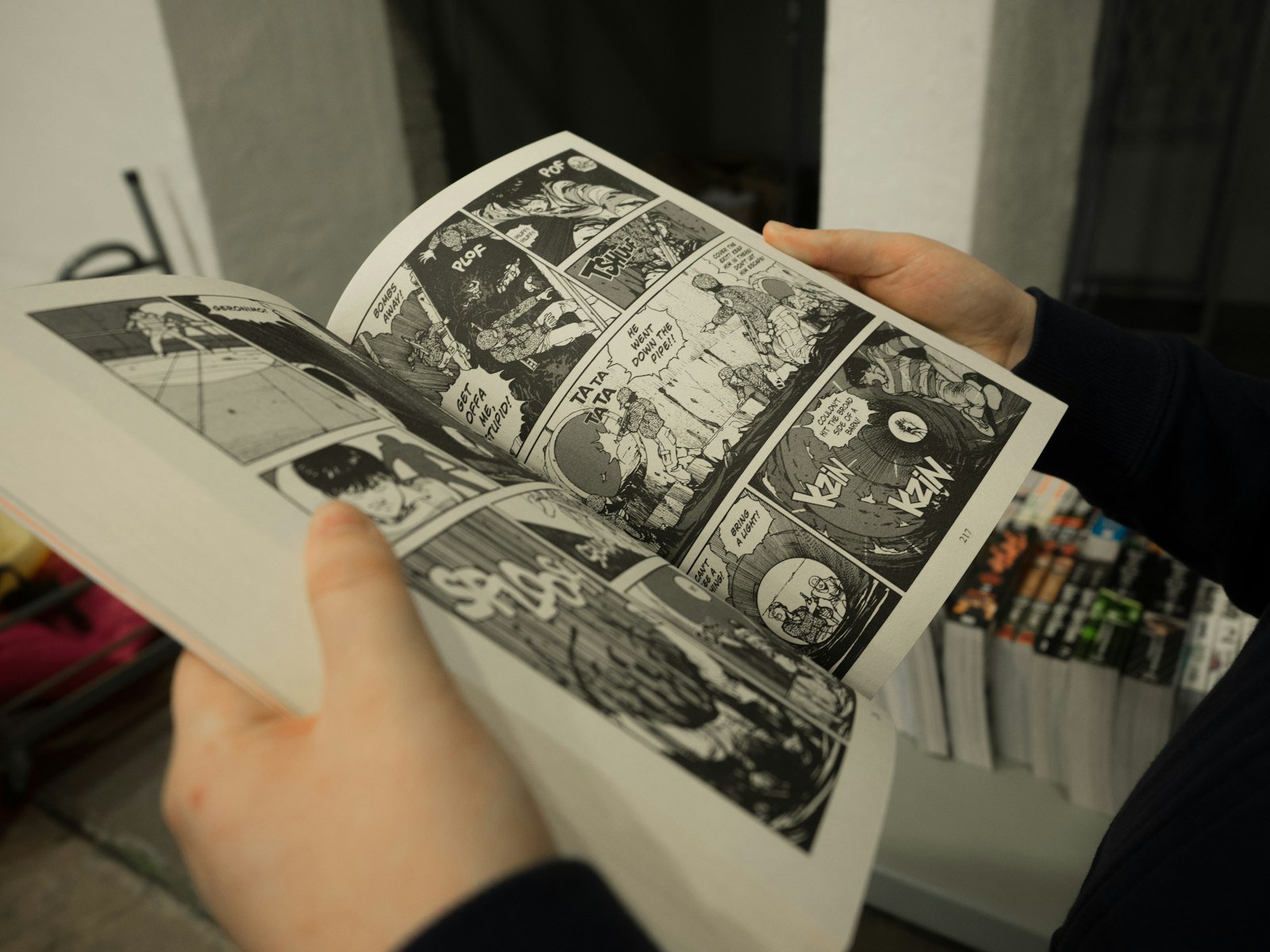Reader holding an open book borrowed from a library